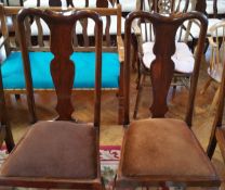 A set of four mahogany reproduction Queen Anne style dining chairs with solid vase shaped splats