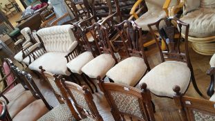 An Edwardian seven piece salon suite with shaped crest rails,