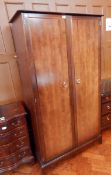 A Stag wardrobe with pair of doors enclosing shelves and hanging space together with a matching
