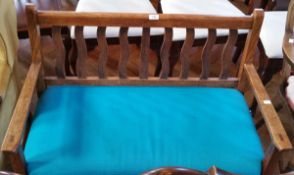 An Edwardian period oak bench seat with upholstered seat