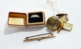 A gold three-stone diamond ring marked 18ct, a lava cameo brooch,
