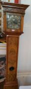 A Georgian style walnut longcase clock with brass chapter ring, striking movement, pendulum window,