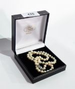 A uniform row of cultured pearls with a paste set clasp