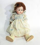 A small German bisque head doll, possibly Heubach Koppelsdorf, incised 