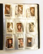 Four albums of cigarette cards including flags, butterflies, aviation, topography, etc.