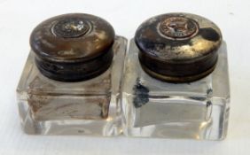 A pair of Mosley's inkwells with glass bases and brass caps