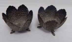 A pair of Indian silver coloured metal posy vases with floral repousse decoration, lobed borders,