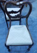 A pair of Victorian mahogany balloon back dining chairs on turned supports