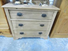An Edwardian bleached pine dressing chest fitted three drawers with oxidised metal handles,