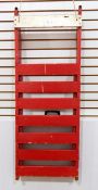 A vintage toboggan/sledge painted red with metal runners