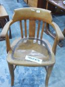 An oak framed tub chair with studded leather upholstered seat