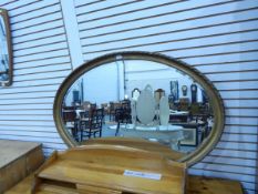 A late Victorian oval wall mirror with bevelled plate and in gilt moulded frame