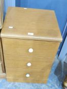 A modern three-drawer bedside chest