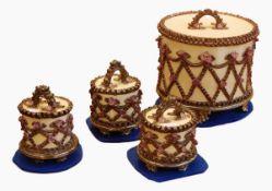 Four pottery cake boxes by Rachel Kneebone, the larger box cylindrical, the lid with arched handle,