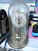 A 400-day two-pillar brass clock under plastic dome,