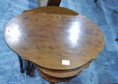 A mahogany nest of three tables on slender turned supports