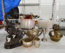 A brass paraffin lamp with glass shade and cast iron holder,