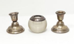 A pair of silver dressing table candlesticks of circular form and a silver mounted glass vesta