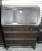 A reproduction stained oak bureau,