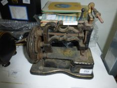 A painted iron and metal hand sewing machine 