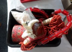 A string of red barrel-shaped beads,