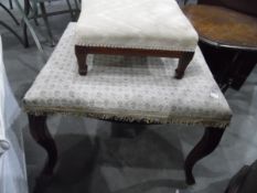 A 19th century mahogany footstool with floral cushion decoration,