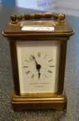 A small brass carriage timepiece