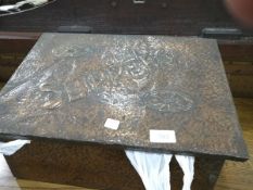 A copper coated slipper box with embossed decoration and 'Slippers' containing bell metal