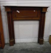 An oak fireplace with circular reeded columns,