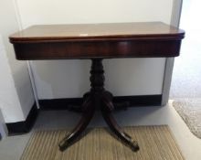 A Victorian mahogany fold-over card table on bulbous turned columns, cabriole legs with paw castors,