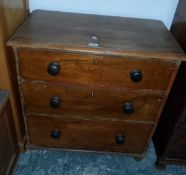 A 19th century pine chest of three graduating drawers with bun handles, on bun feet,