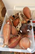 A quantity of African water carrying gourds and other vessels some with lids and some bead