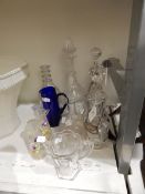 A Georgian cut glass decanter with triple ring neck, another Georgian decanter, an etched decanter,