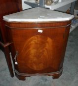 A mahogany bowfront corner cupboard with marbled top, raised on bracket feet,