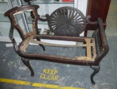An Edwardian mahogany settee, the show frame with central pierced and carved oval scroll arms,