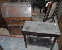 Oak stained table and an oak bureau with carved decoration and brass hinges