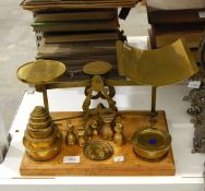 A set of brass parcel scales, limit of weight 11lbs, with brass weights,