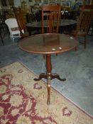 A Georgian mahogany tilt-top tripod table with baluster stem