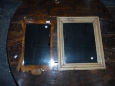 A walnut framed mirror with scroll top together with a pine mirror