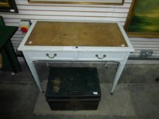 A painted writing table fitted with two drawers, leather inset top, on turned legs