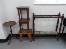 An early 20th century mahogany umbrella stand with turned supports and five compartments with drip