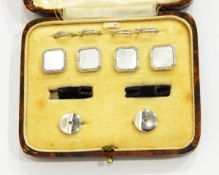 A set of four mother-of-pearl buttons and a pair of matching collar studs of square design,