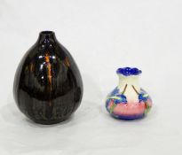 A Poole pottery vase of ovoid form decorated in brown, green and orange glazes,