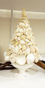 A collection of shells mounted on ceramic pedestal bowl,