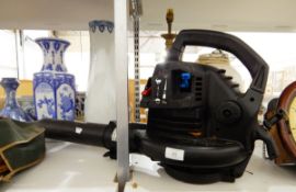 A petrol driven leaf blower and two golf club bags and contents