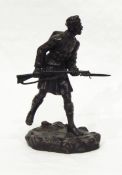 A bronze model of WWI soldier carrying rifle, signed indistinctly 