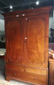 An early 20th century Howard & Son mahogany bedroom suite viz:- dressing table, hanging wardrobe,