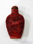 A carved cinnabar lacquer snuff bottle decorated with horses