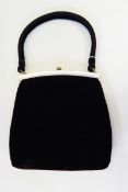 A 1950's Ingber velvet evening bag with brass-coloured fixed frame, one side trimmed with bakelite,
