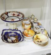 A Noritake shaped oval bowl painted with a lake landscape, within blue and floral borders,